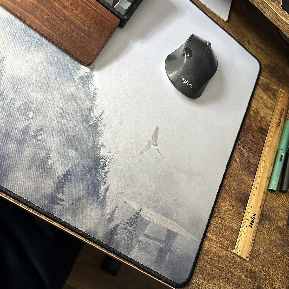 A computer mouse sitting on a desk mat.